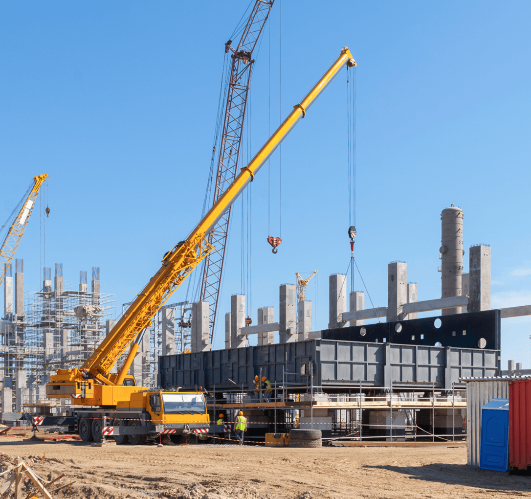 Operated crane lifting construction and industrial equipment skyward in Phoenix